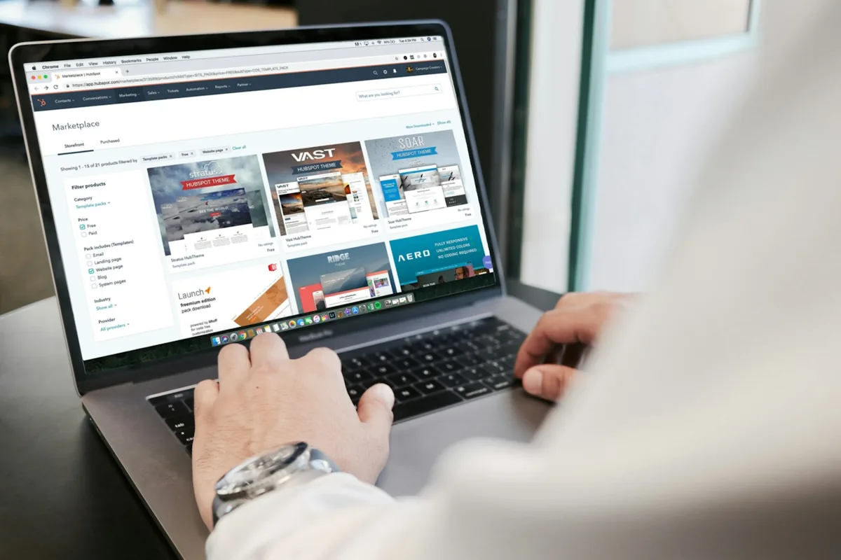 A person browsing a website template marketplace on a laptop